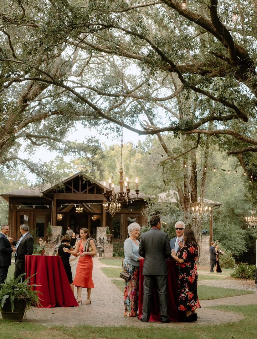 Outdoor wedding reception under trees.