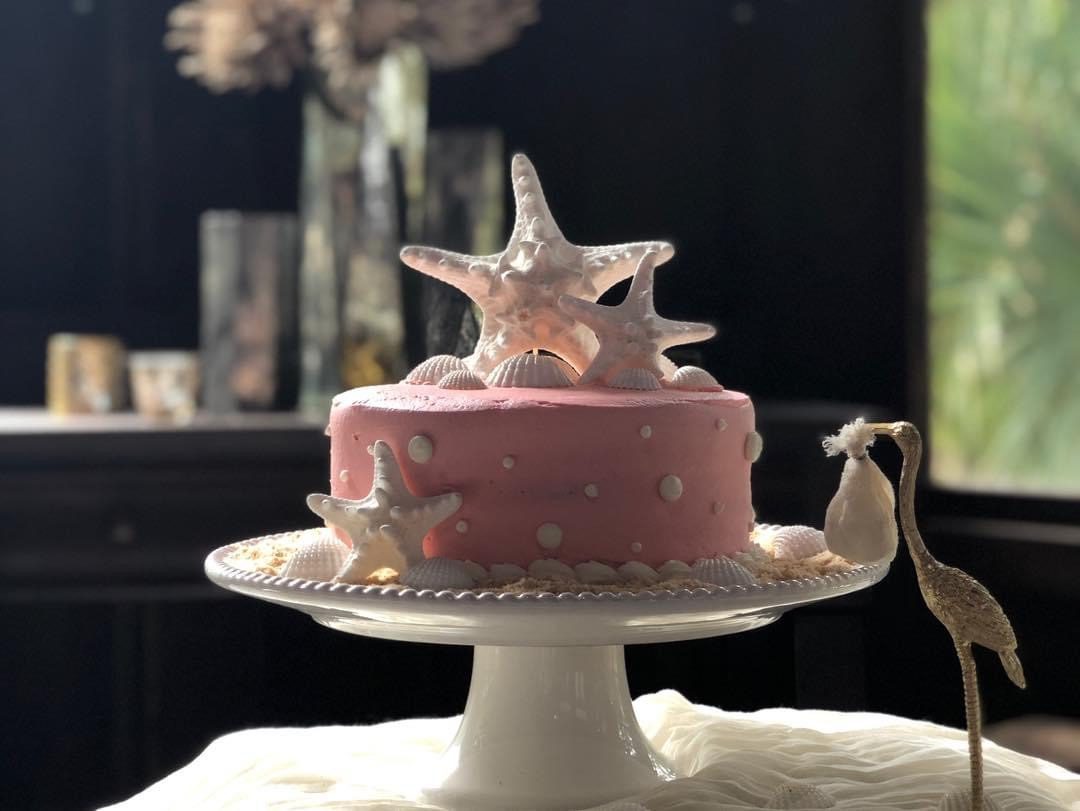Pink beach-themed cake with starfish.