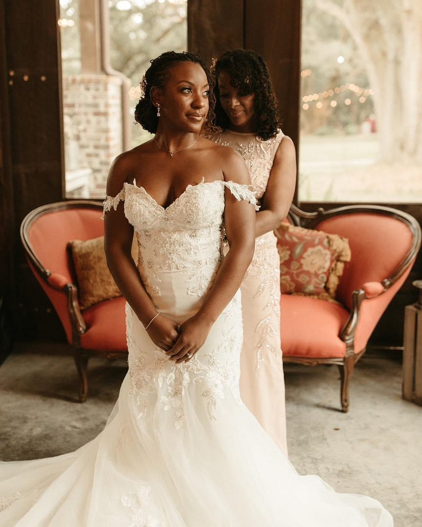 Bride getting ready in wedding dress.