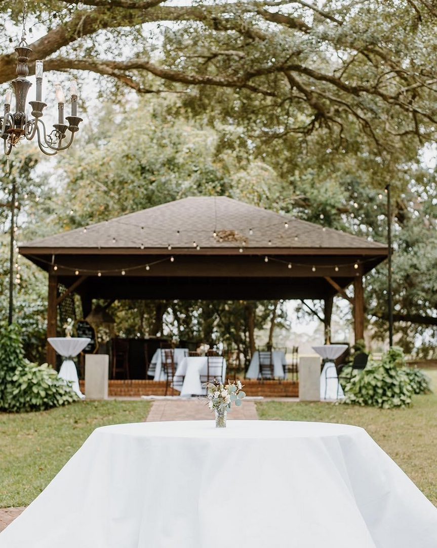 Wedding reception table under a gazebo.