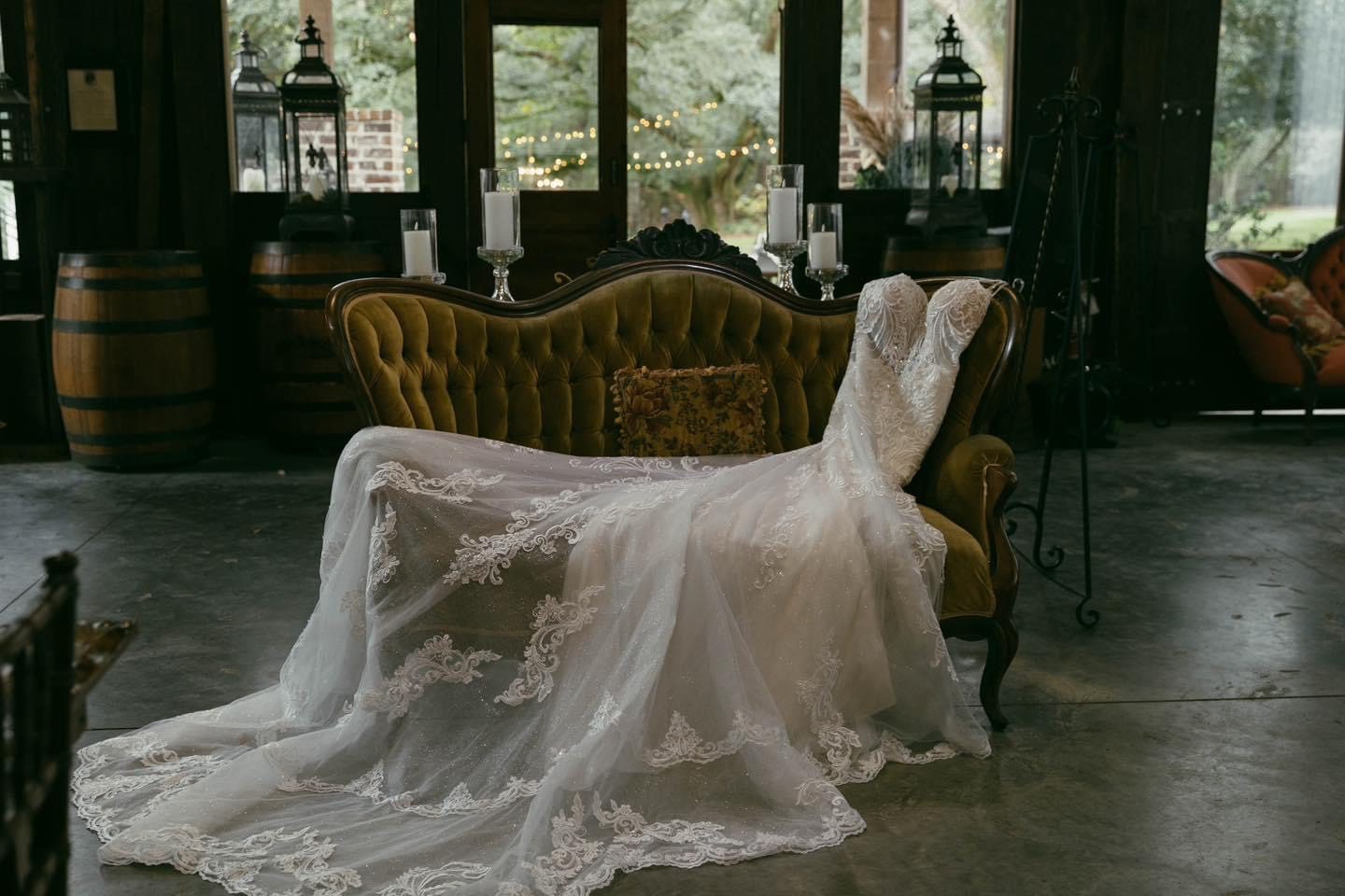Lace wedding dress on vintage couch.