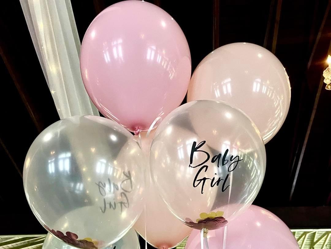 Pink and clear baby girl balloons.