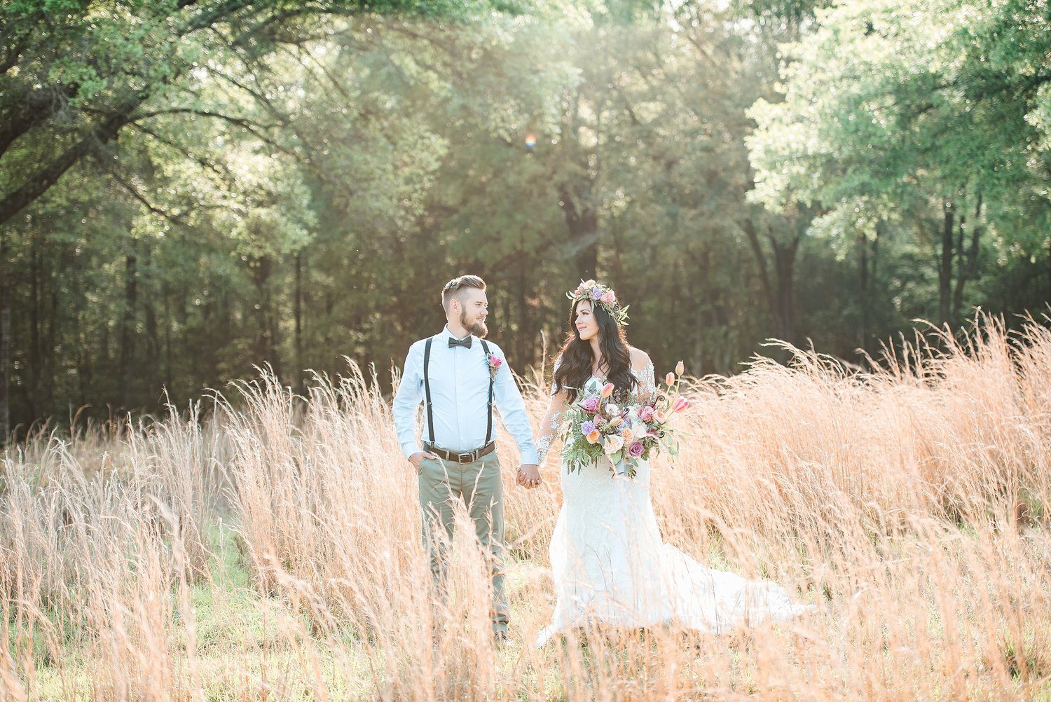 Bride and groom in a field.