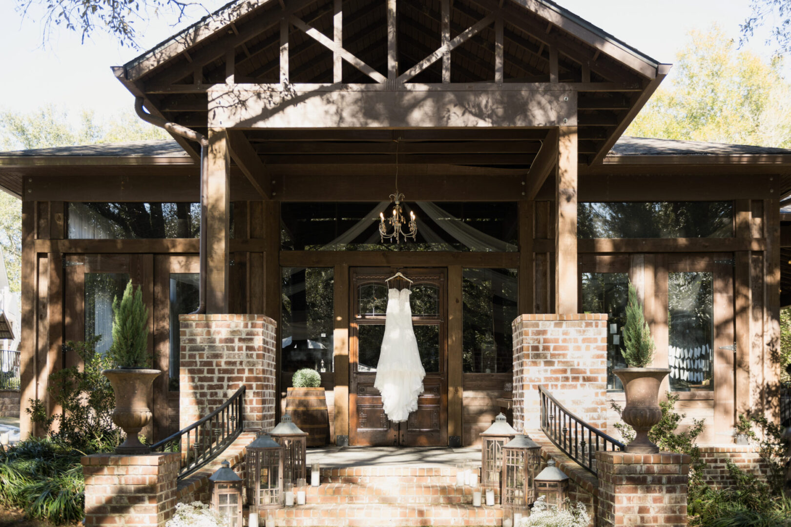 Wedding dress hanging on rustic porch.