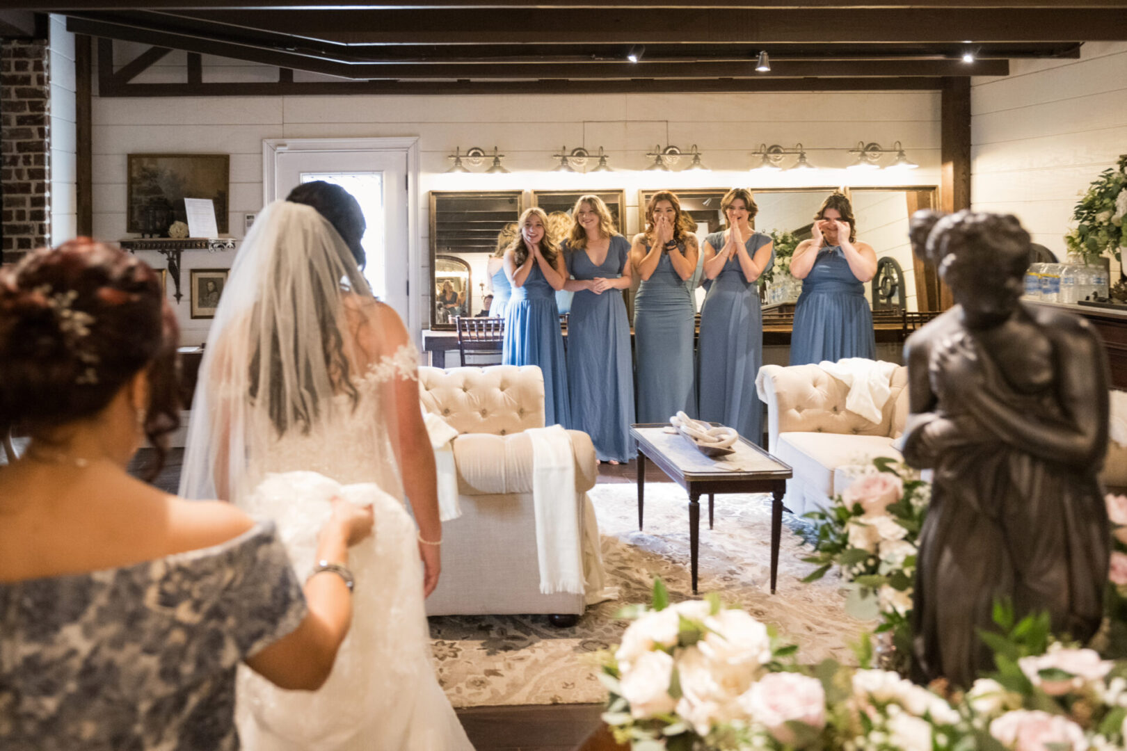 Bride sees bridesmaids in blue dresses.