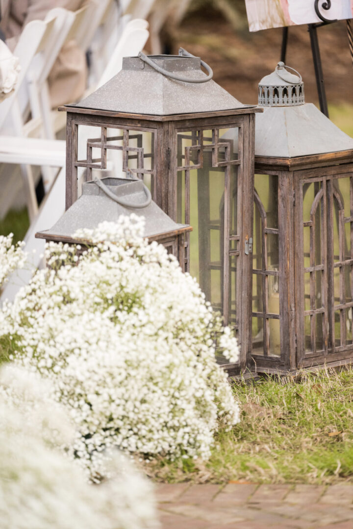 Wooden lanterns with white flowers.