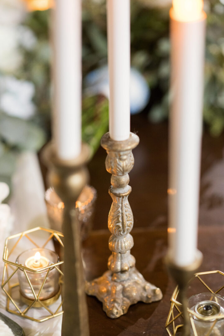 Ornate candle holders with lit candles.