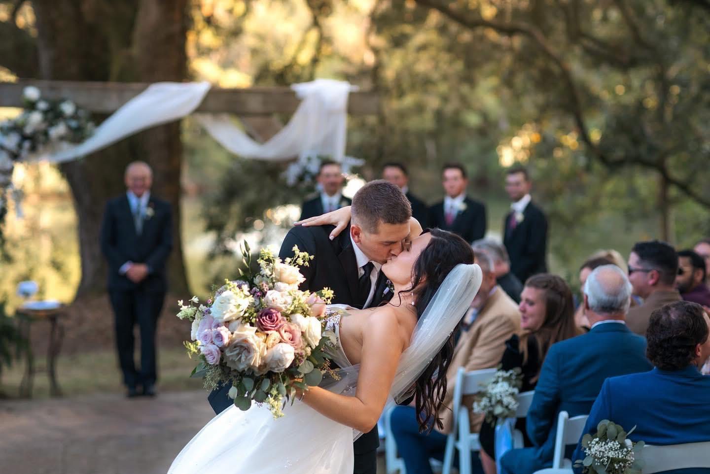 Bride and groom kissing at wedding.