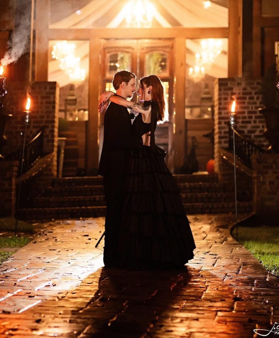 Couple embracing, nighttime romantic dance.