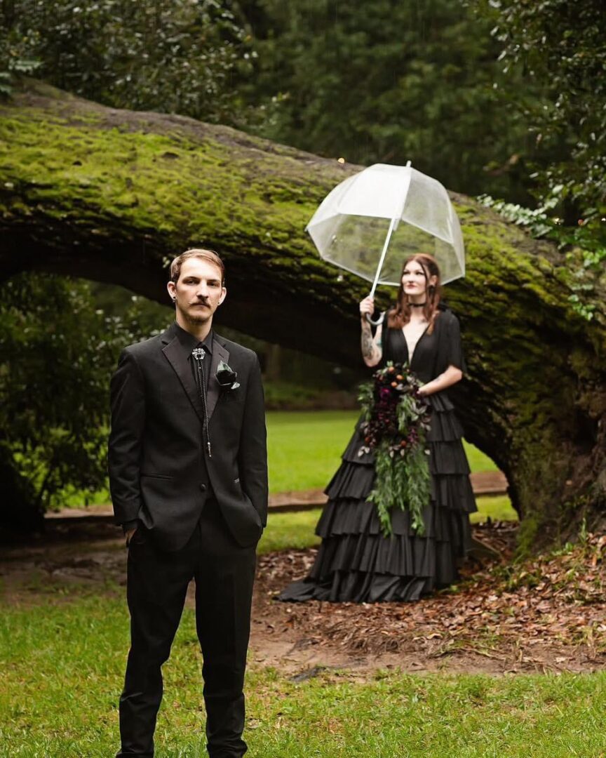 Gothic wedding couple under a tree.