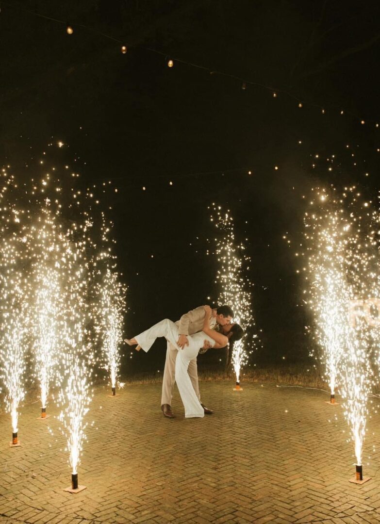 Couple kissing amidst sparkling fireworks.