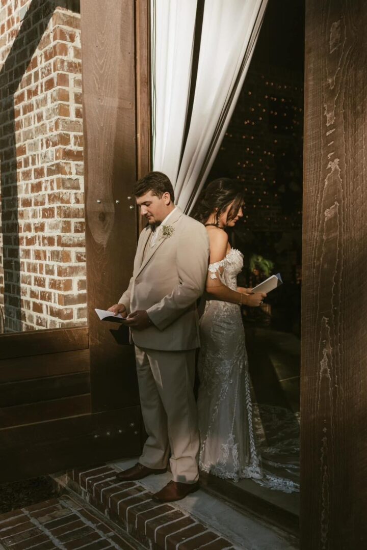 Bride and groom reading vows before wedding.