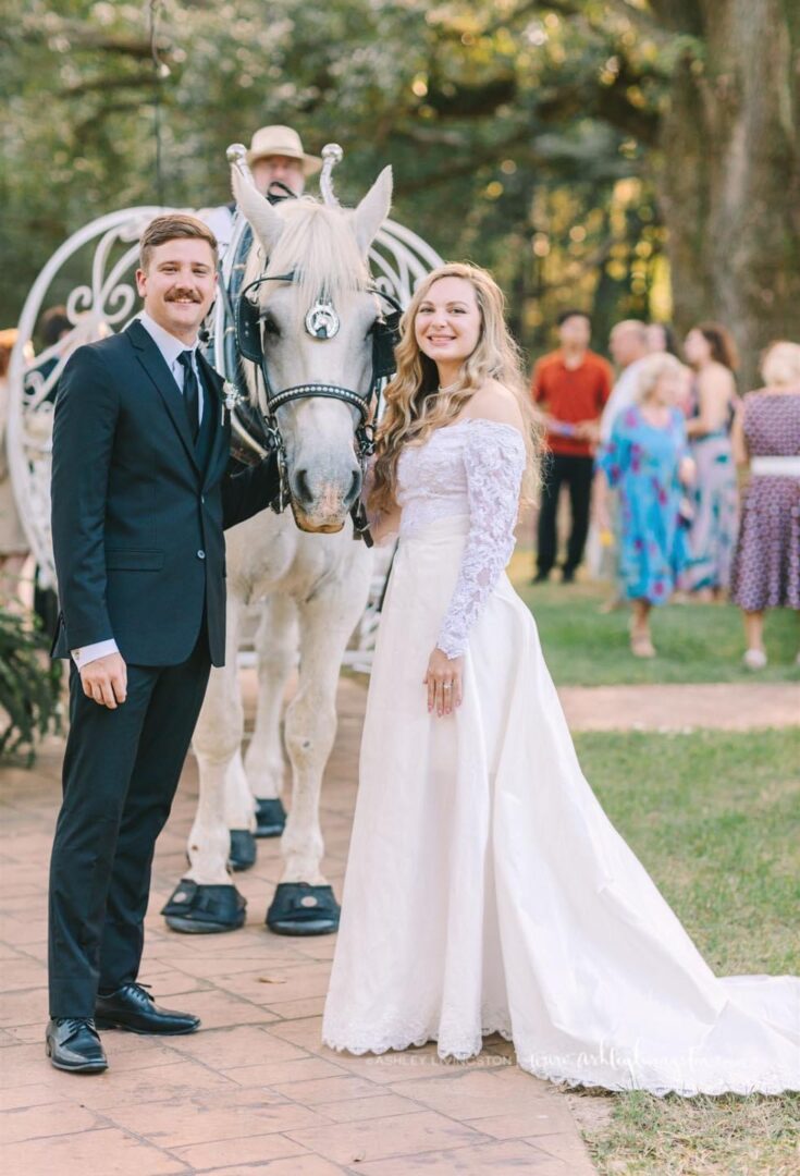 Bride and groom with wedding horse.