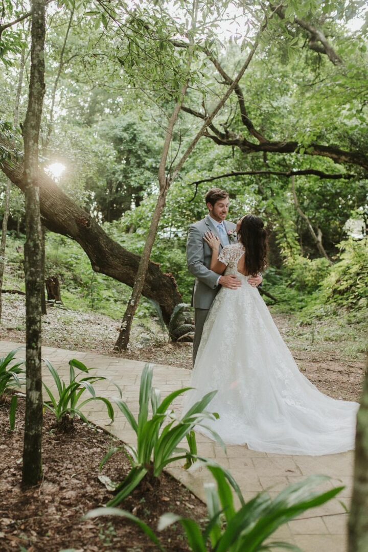 Happy wedding couple embracing in woods.