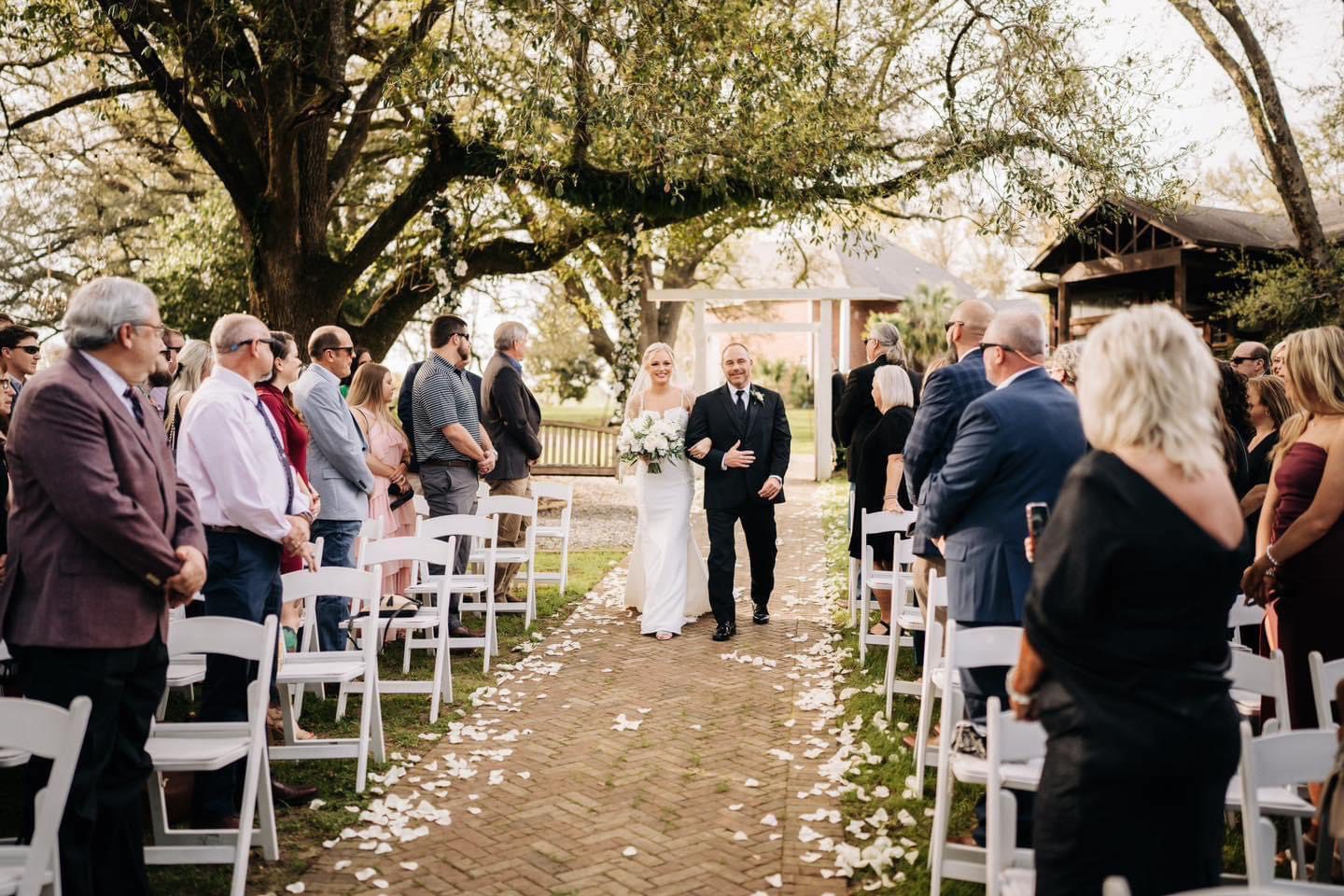 Bride and father walking down aisle.
