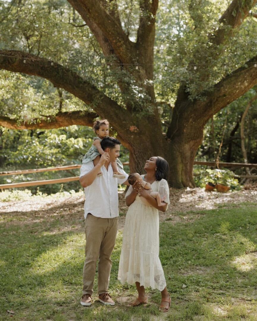 Happy family with two children outdoors.