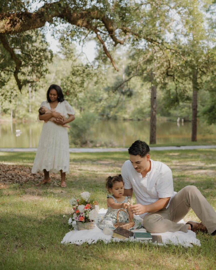 Family picnic in park; dad and daughter.