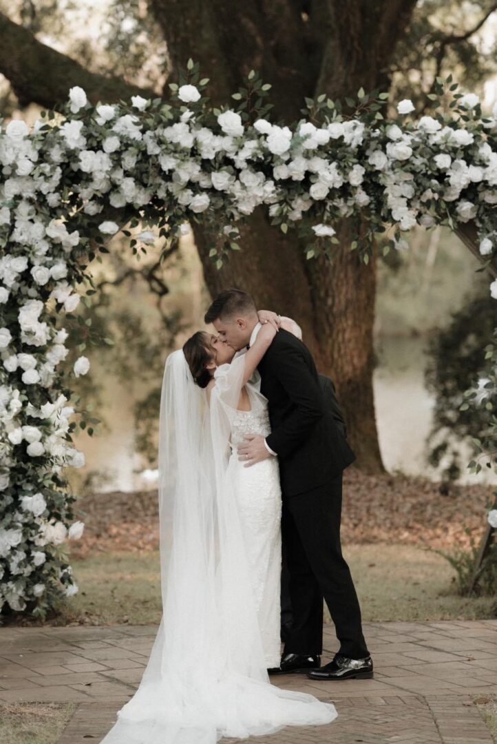 Bride and groom kissing at wedding.