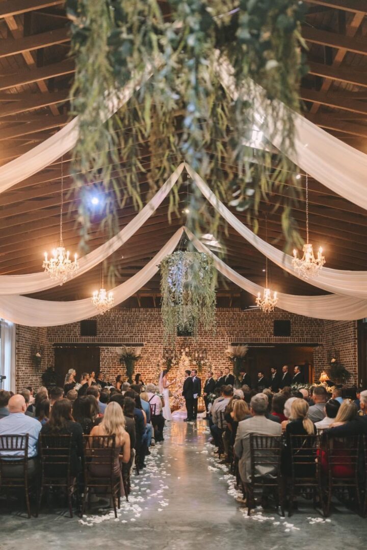 Wedding ceremony in rustic barn venue.