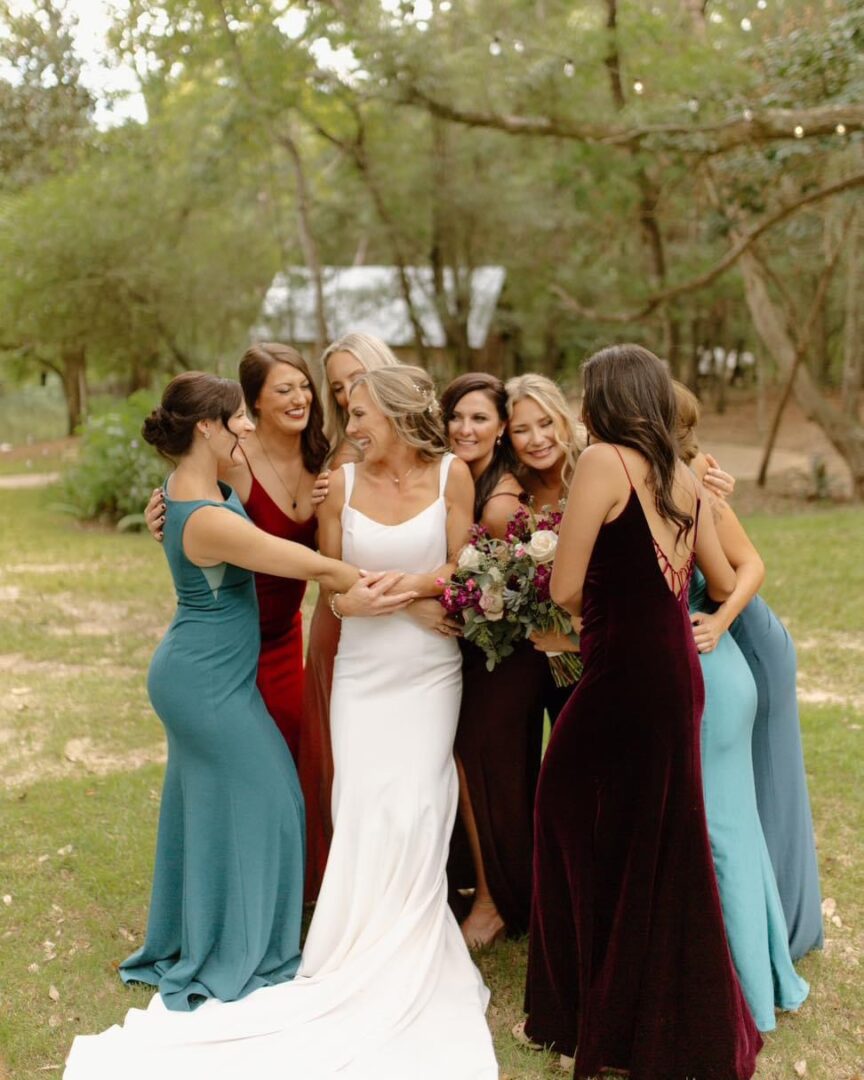 Bride and bridesmaids smiling together.