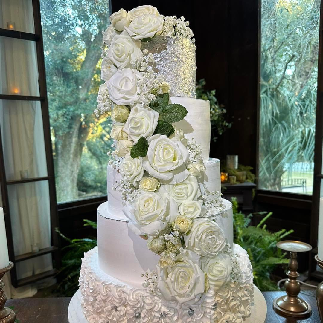 Elegant white wedding cake with roses.