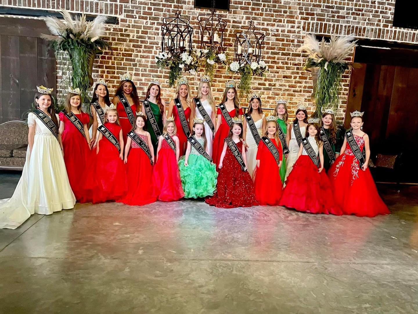 Pageant winners in formal gowns.