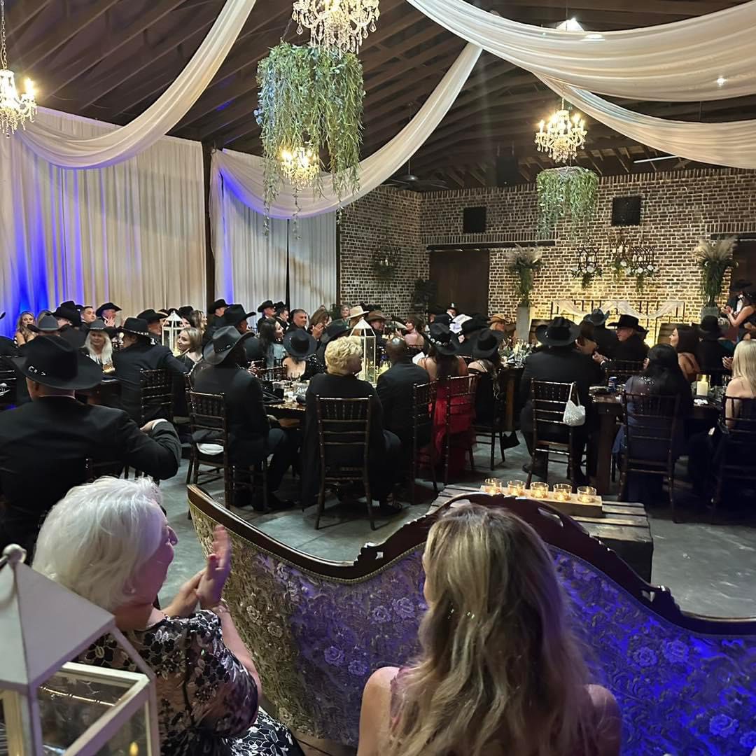 Wedding reception guests in a rustic venue.