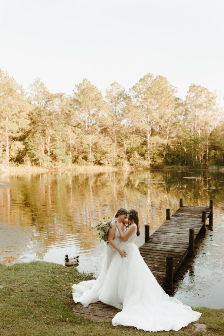 Lesbian couple wedding by lake.