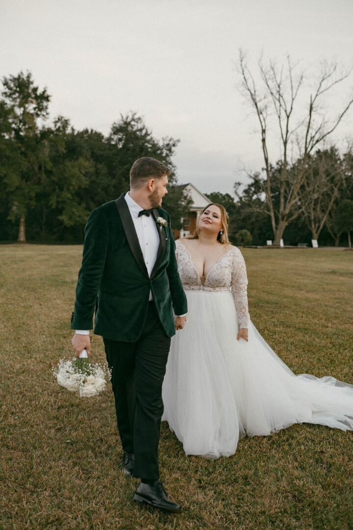 Newlywed couple walking, holding hands.