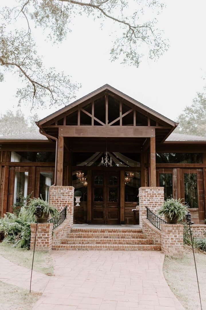 Rustic brick building entrance with stairs.