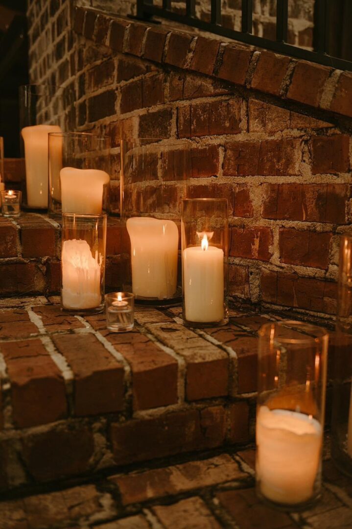 Candles on brick steps at night.