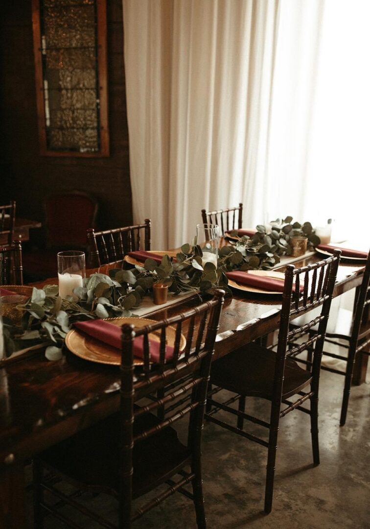 Rustic wedding table setting with greenery.