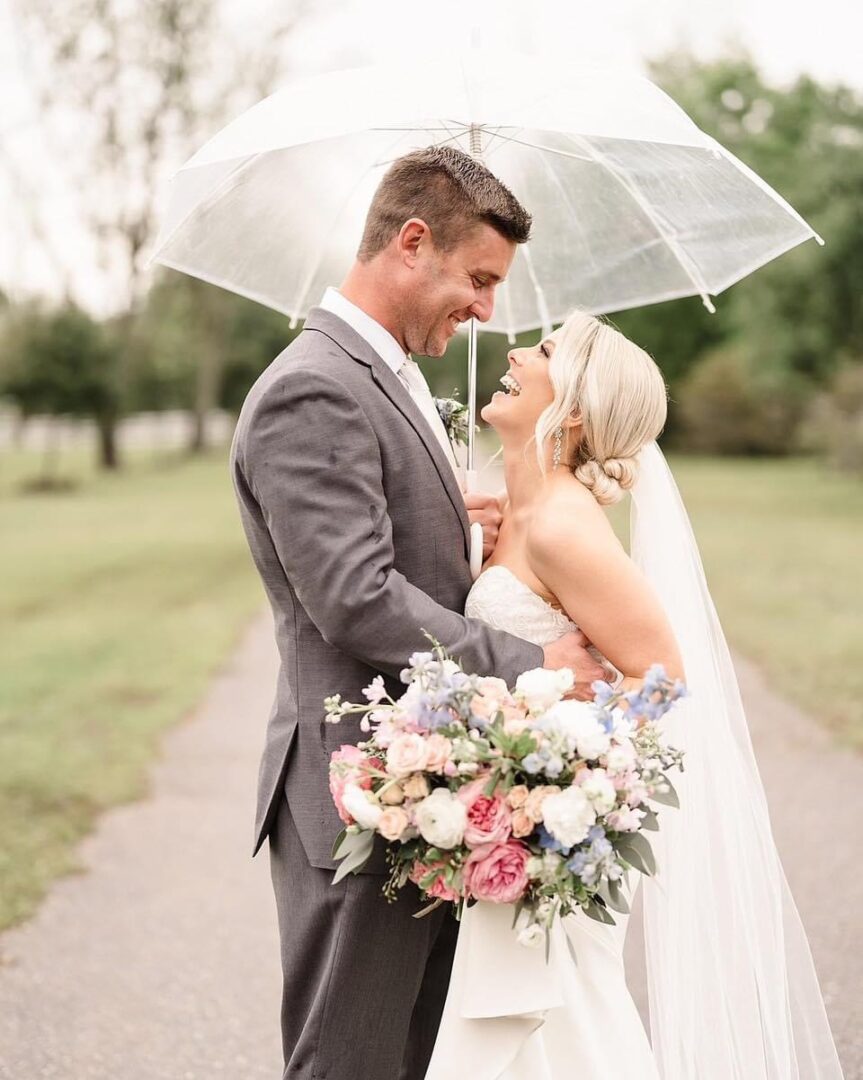 Happy wedding couple under umbrella.