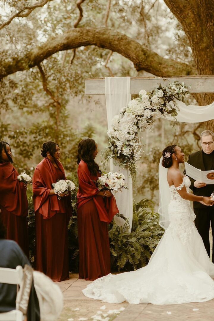 Outdoor wedding ceremony with bridesmaids.