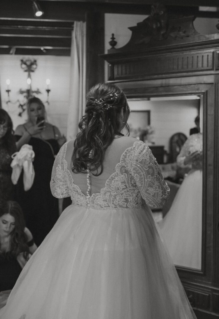 Bride in lace wedding dress, back view.
