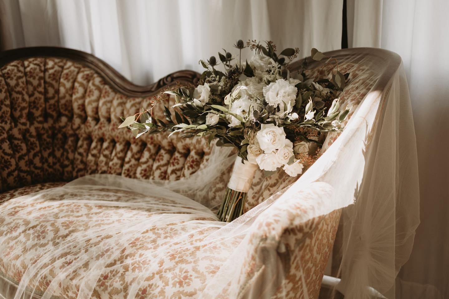 Wedding bouquet on vintage couch.