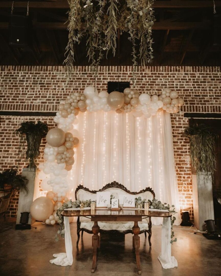 Wedding sweetheart table with balloon arch.