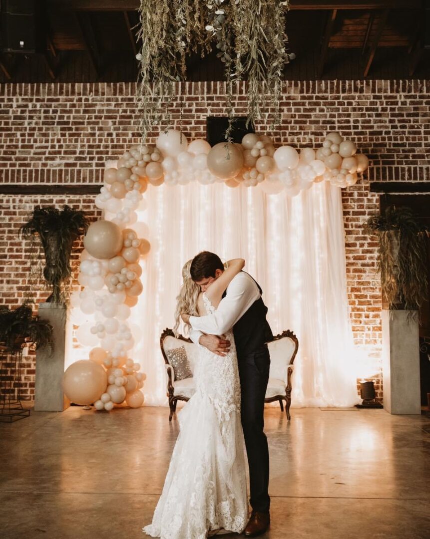 Bride and groom embrace at wedding.