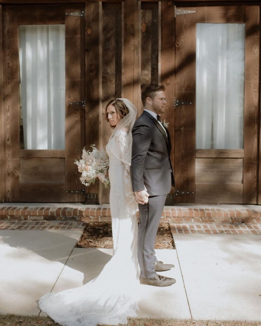 Bride and groom holding hands before wedding.