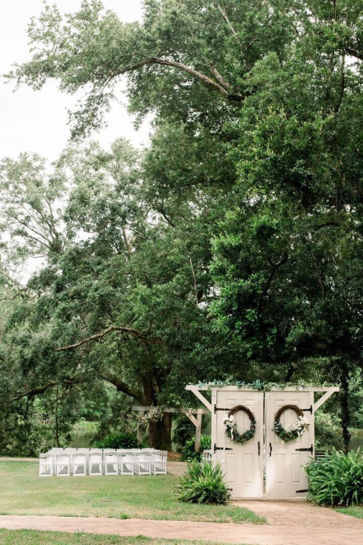 Outdoor wedding ceremony with white doors.