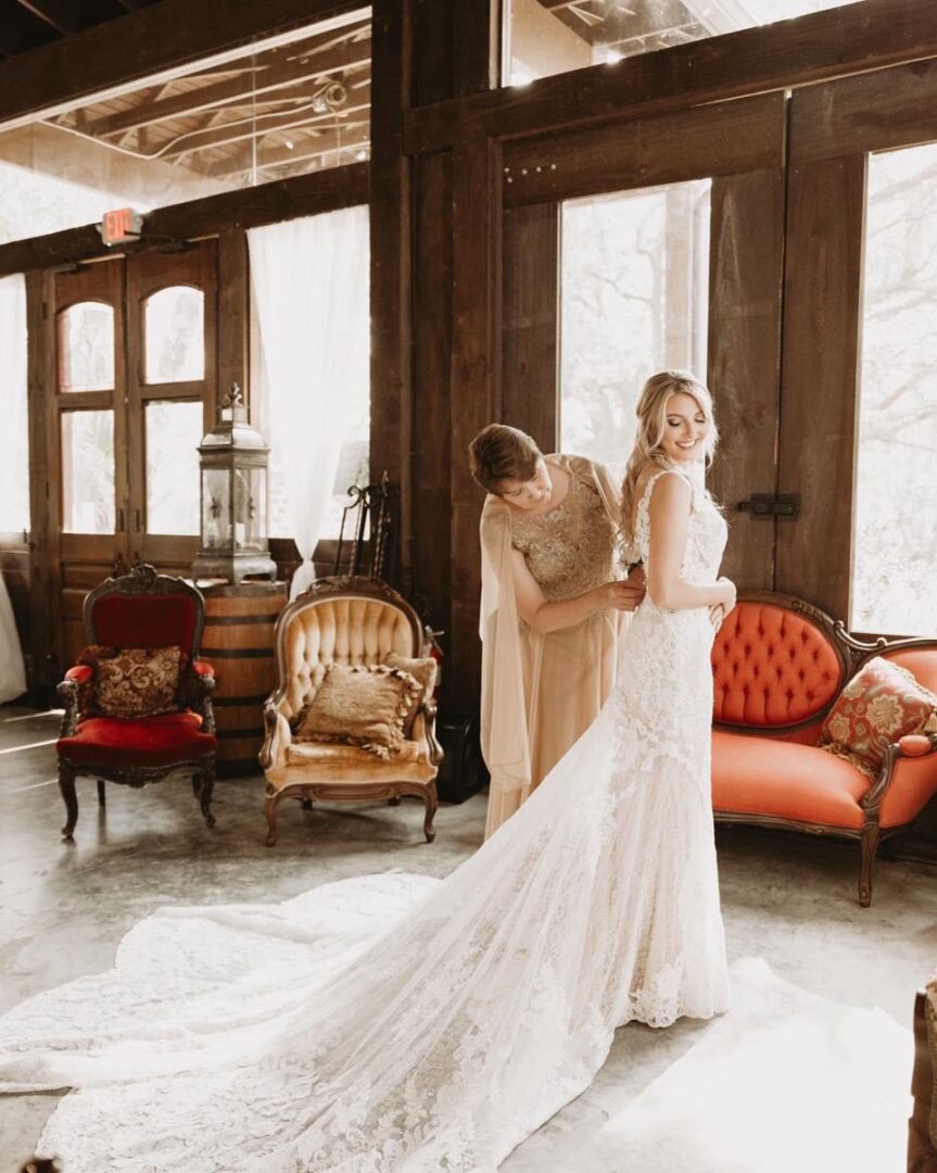 Bride getting ready in rustic venue.