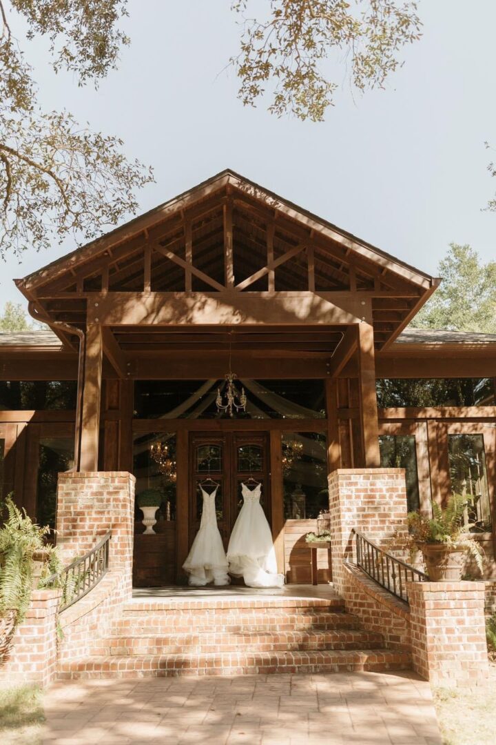 Two wedding dresses on porch steps.