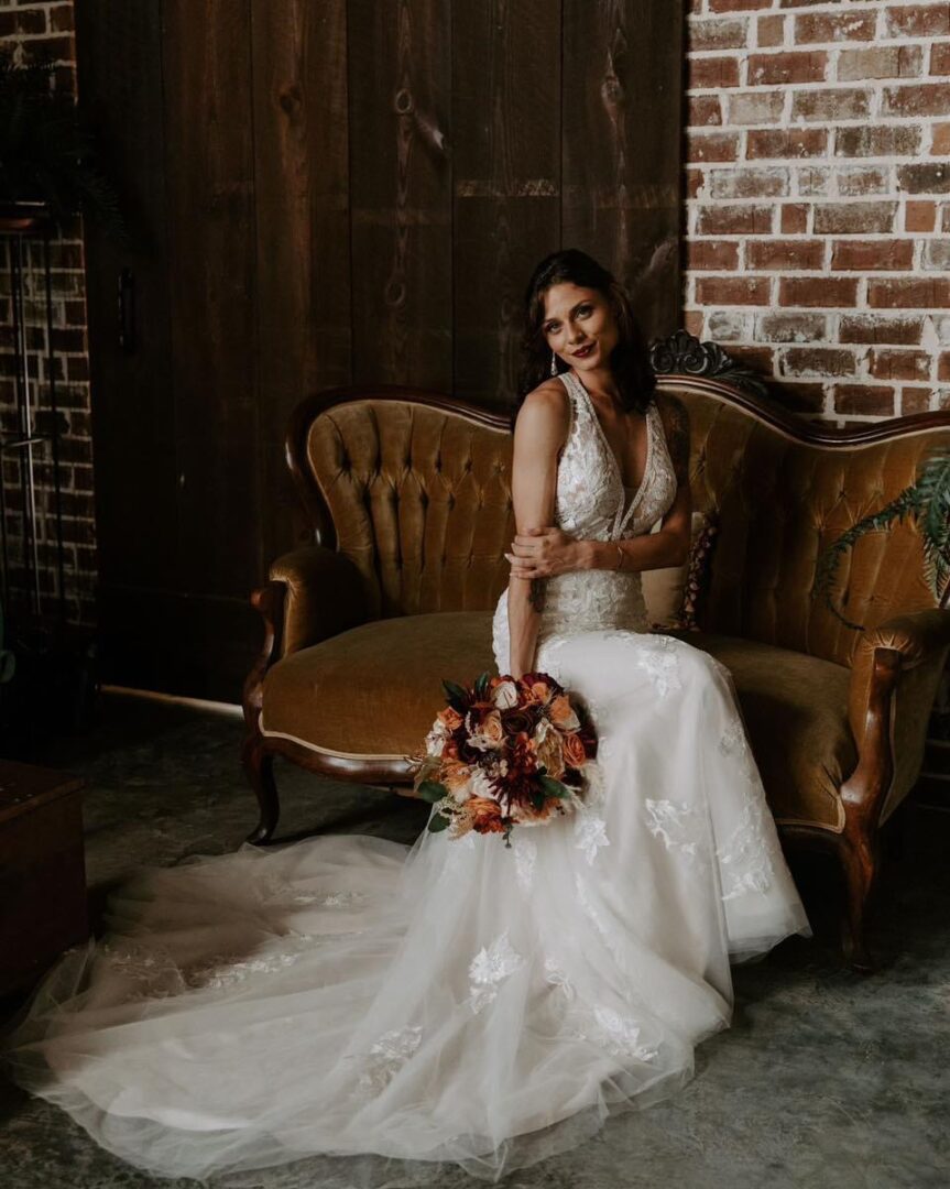 Bride in lace wedding gown with bouquet.