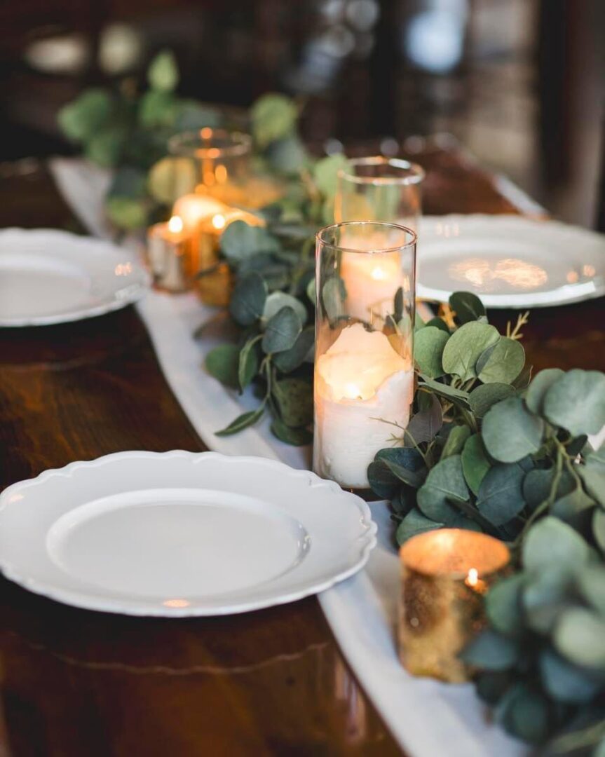 Candles and plates on a table.