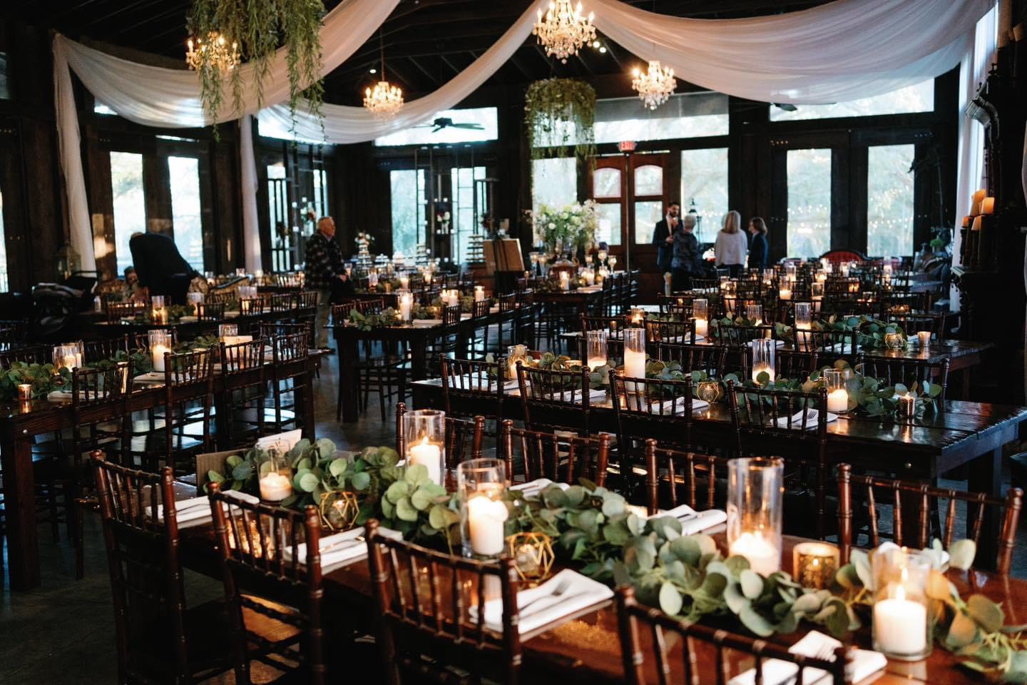 Rustic wedding reception candlelit tables.