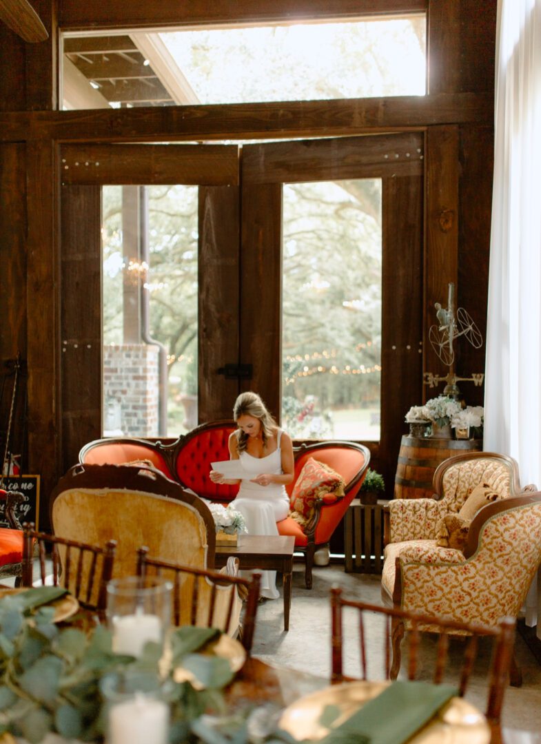 Bride reading letter in rustic room.