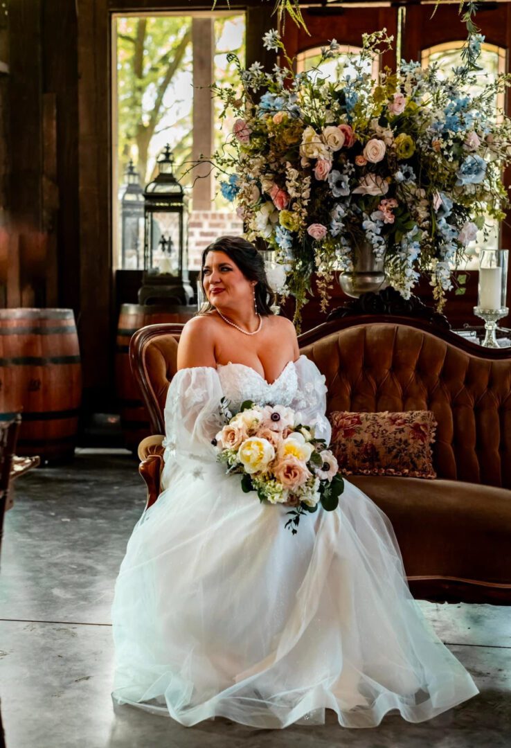 Bride in wedding dress, holding bouquet.