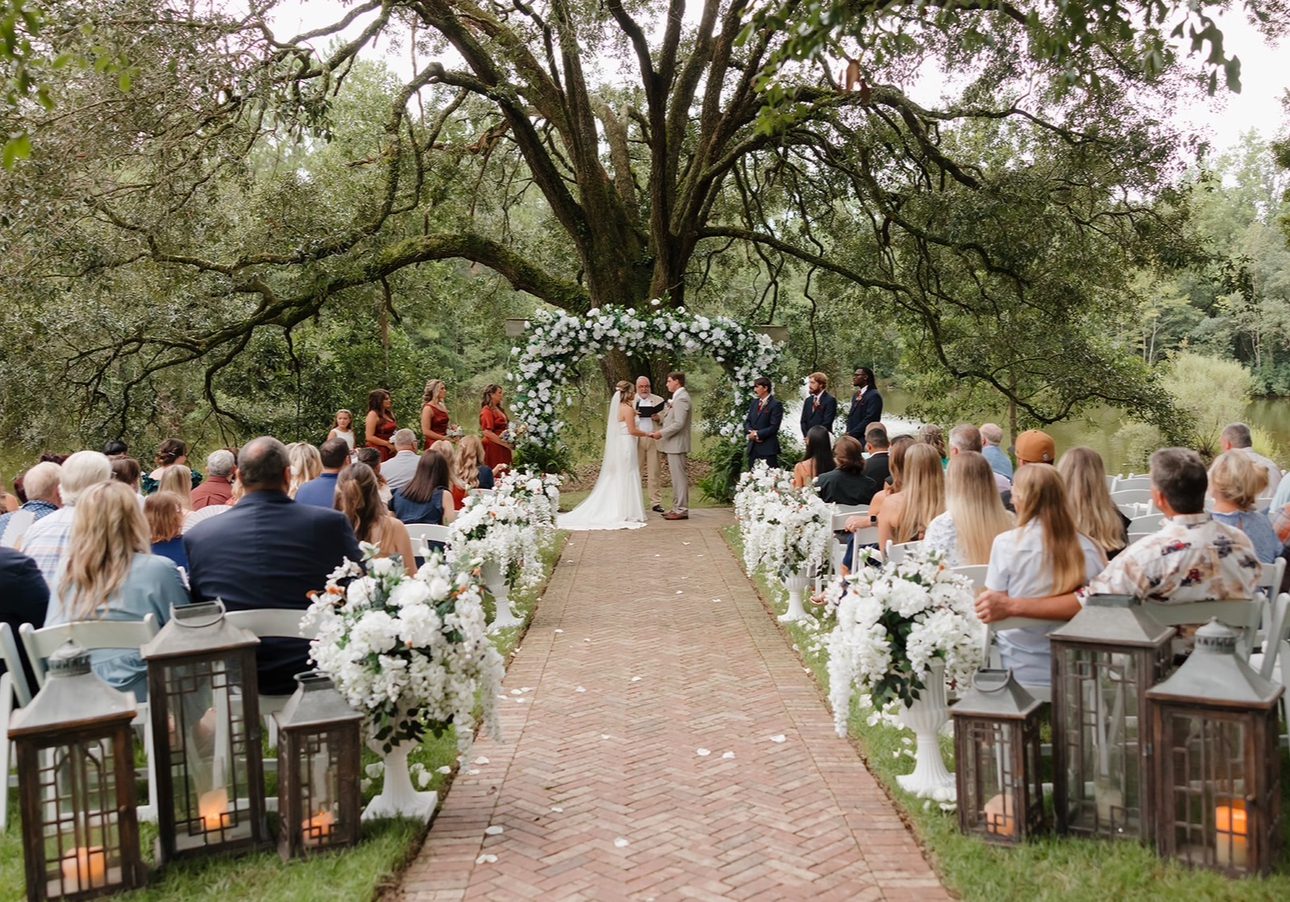 Outdoor wedding ceremony under a tree.