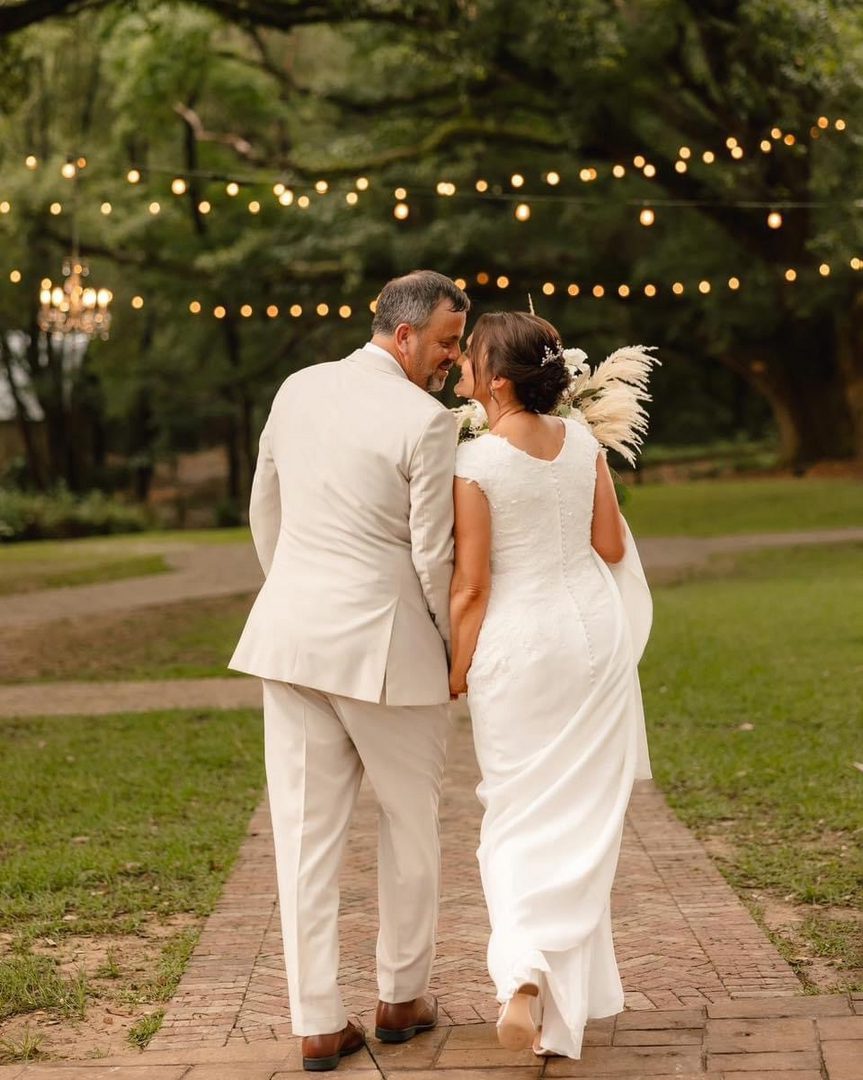 Bride and groom walking, hand-in-hand.