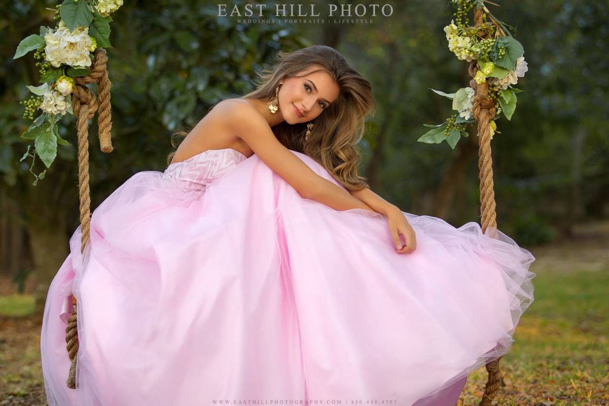Girl in pink dress on swing.